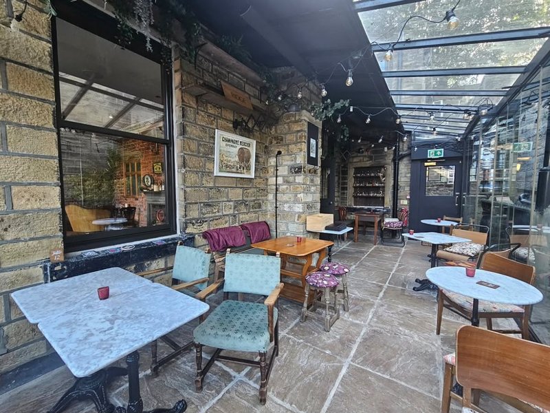 The conservatory, with tables under a glass roof